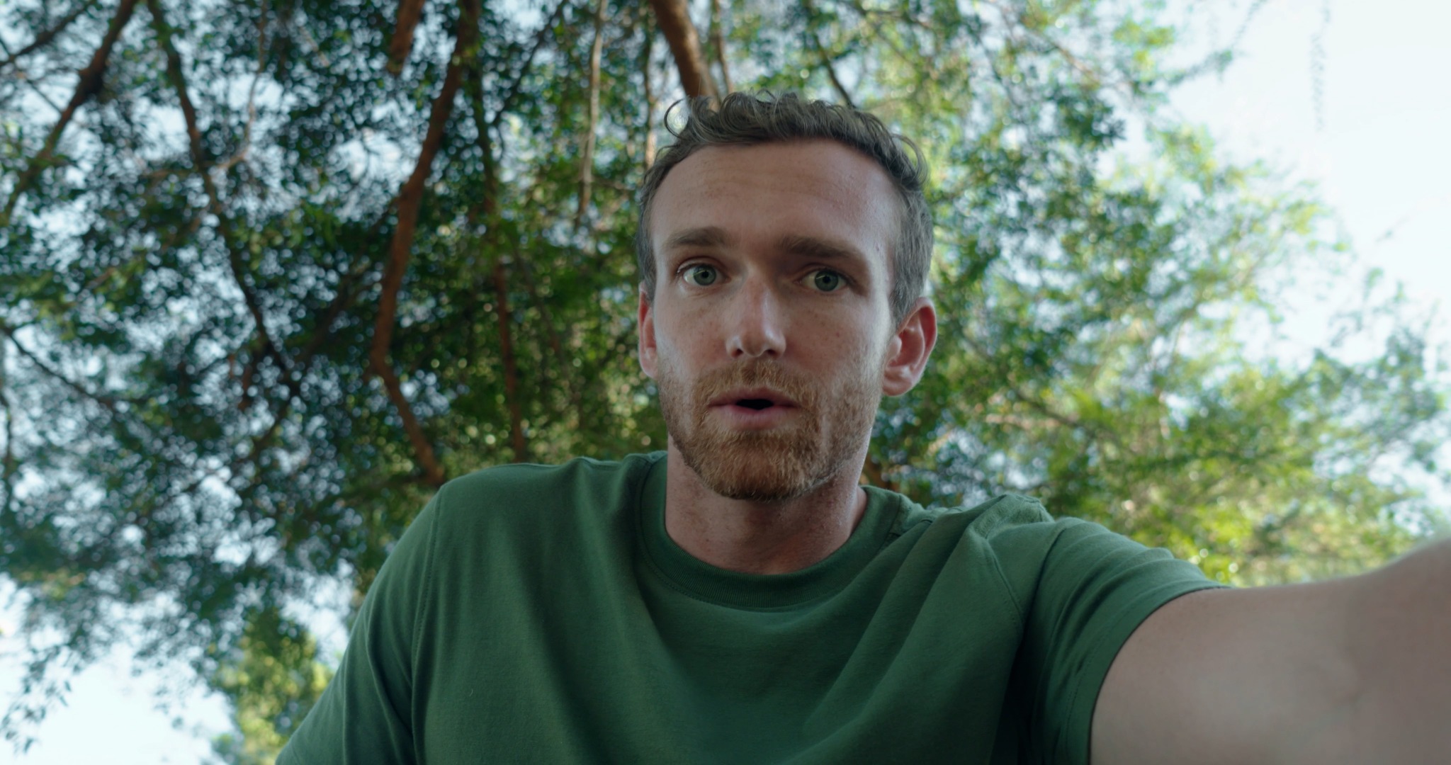 A close-up outdoors beneath trees, from Brotherhood.