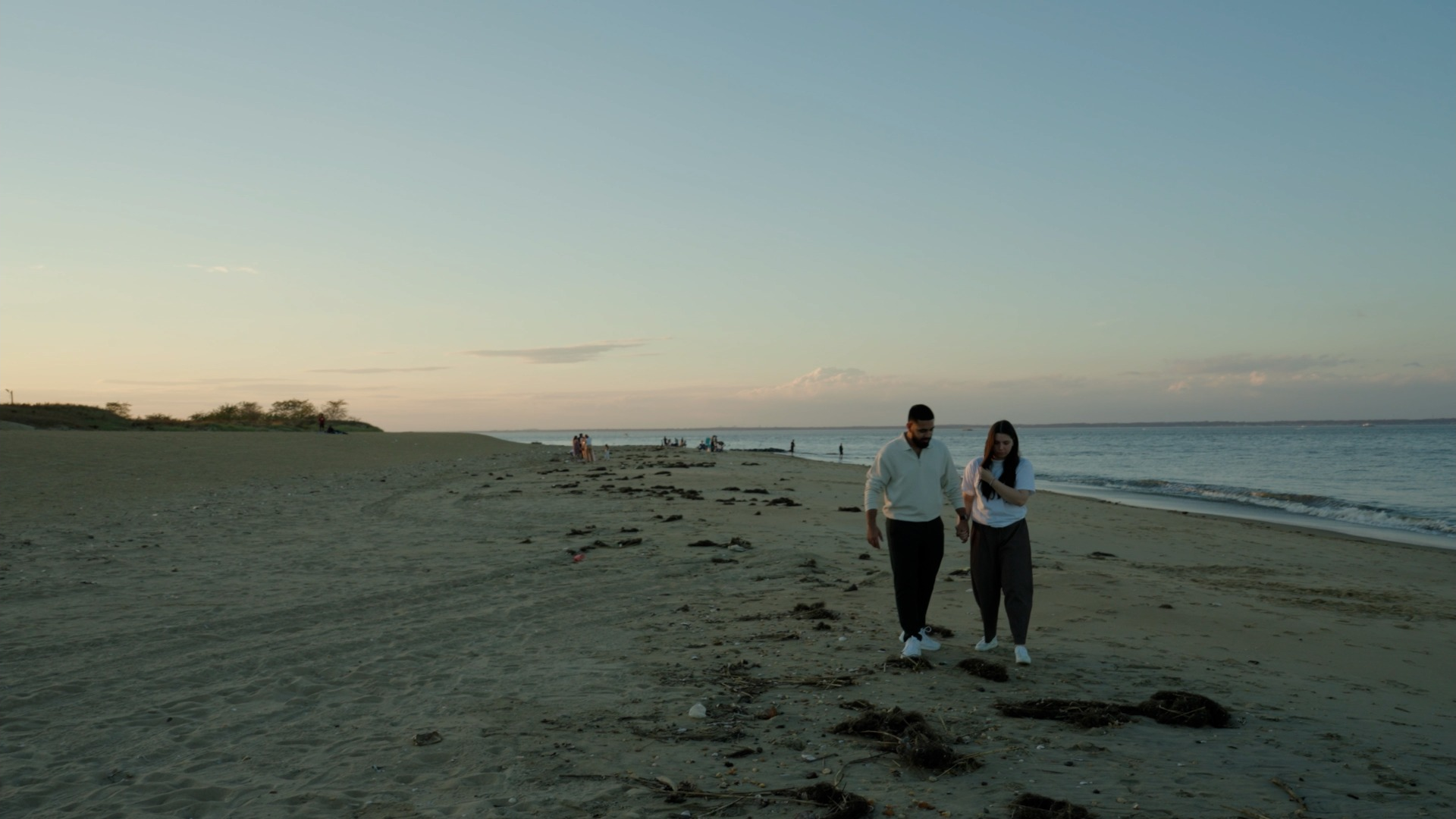 Two people walking together along a beach at dusk, from Souls Color.